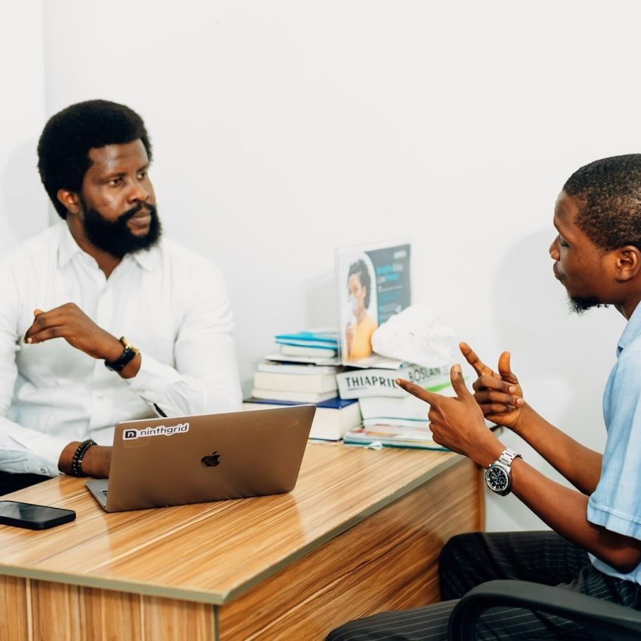 A candid interaction between a man and woman during a professional interview in a modern office setting.